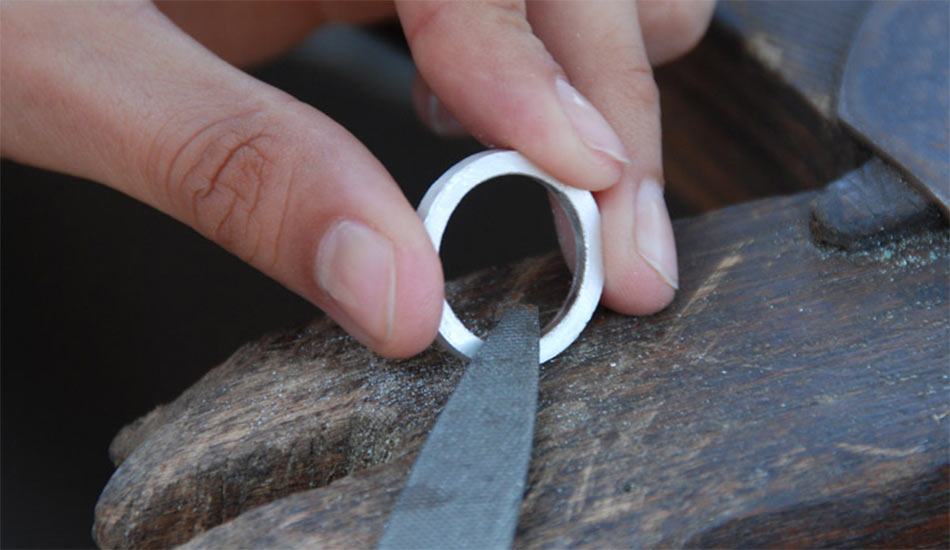 A silver ring is filed